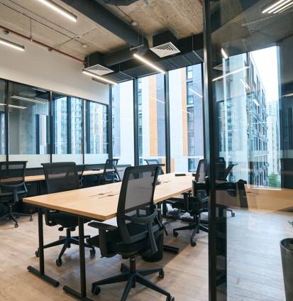 Interior photo of office decoration in loft style with transparent partition and functional furniture